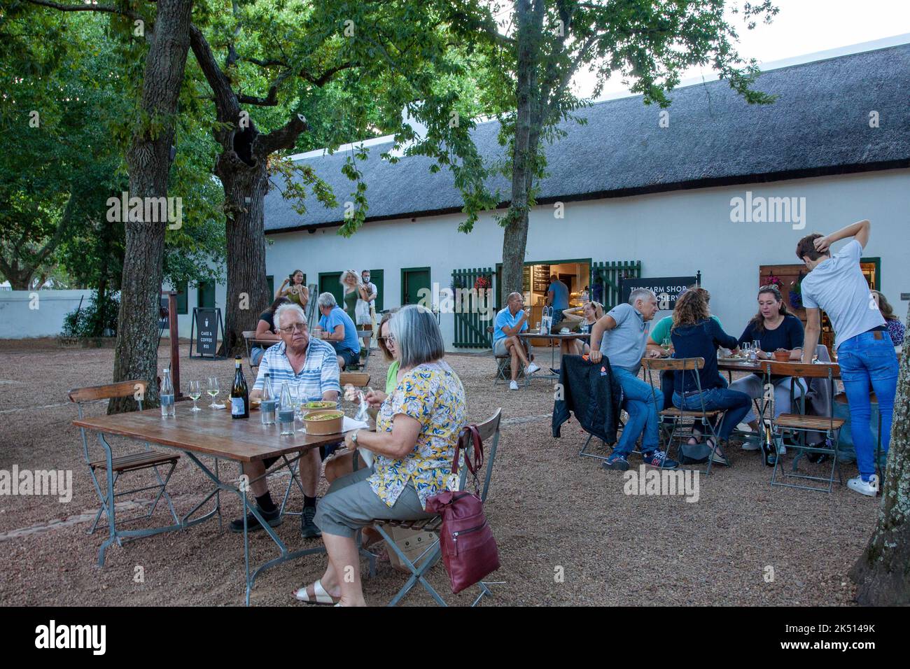 Visitors Drinking at Outdoor Tables at Boschendal Night Market  in Western Cape, South Africa Stock Photo