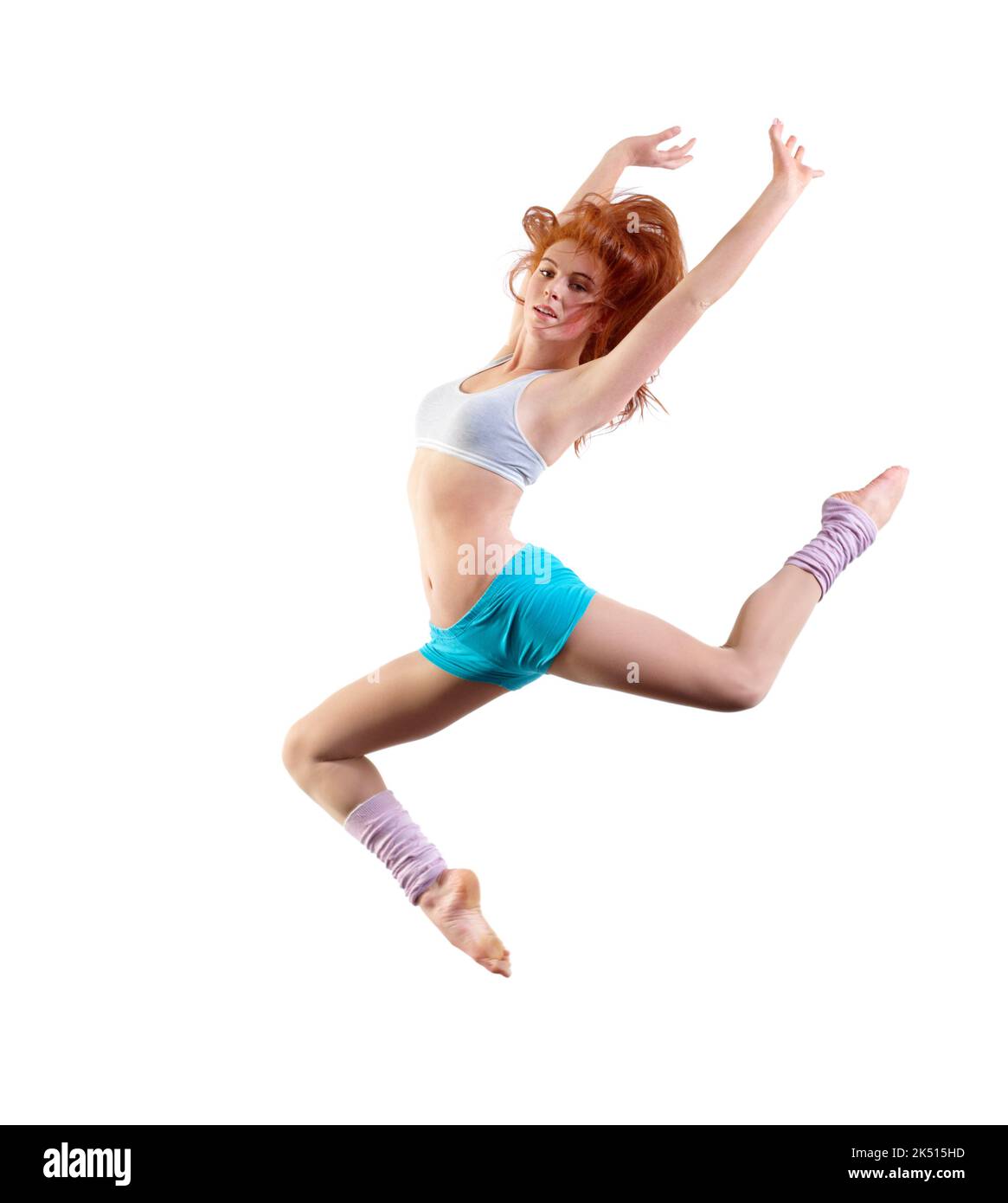 Feeling her passion for dance. Young dancer jumping against a white background. Stock Photo