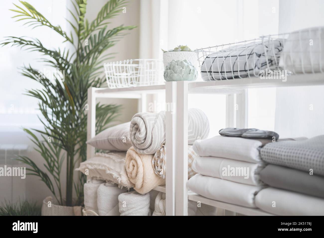 Wardrobe in the bedroom with neatly folded linen vertical storage and