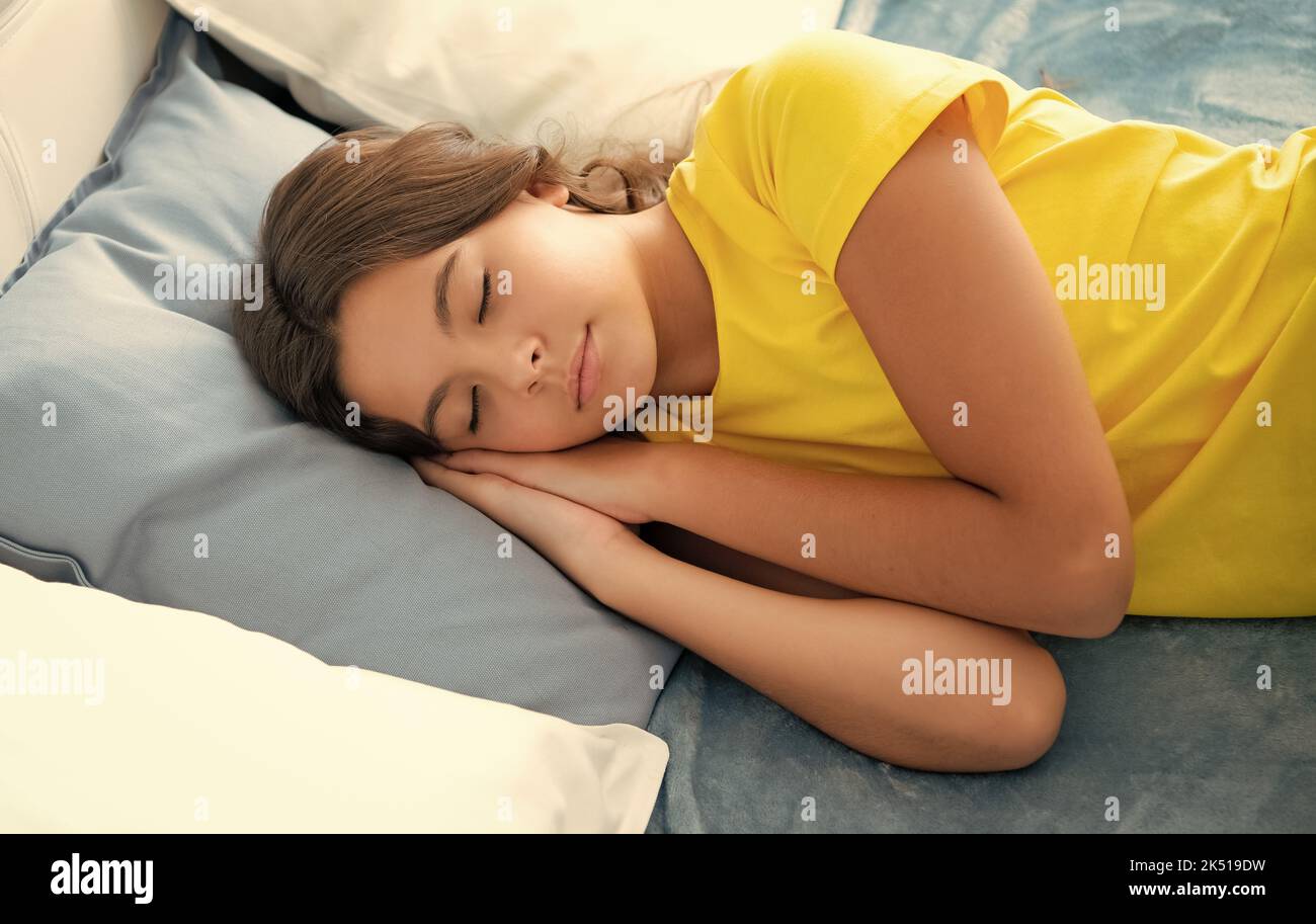 Kid lying and sleeping on bed. Child teen sleeps in the bed. Teenager