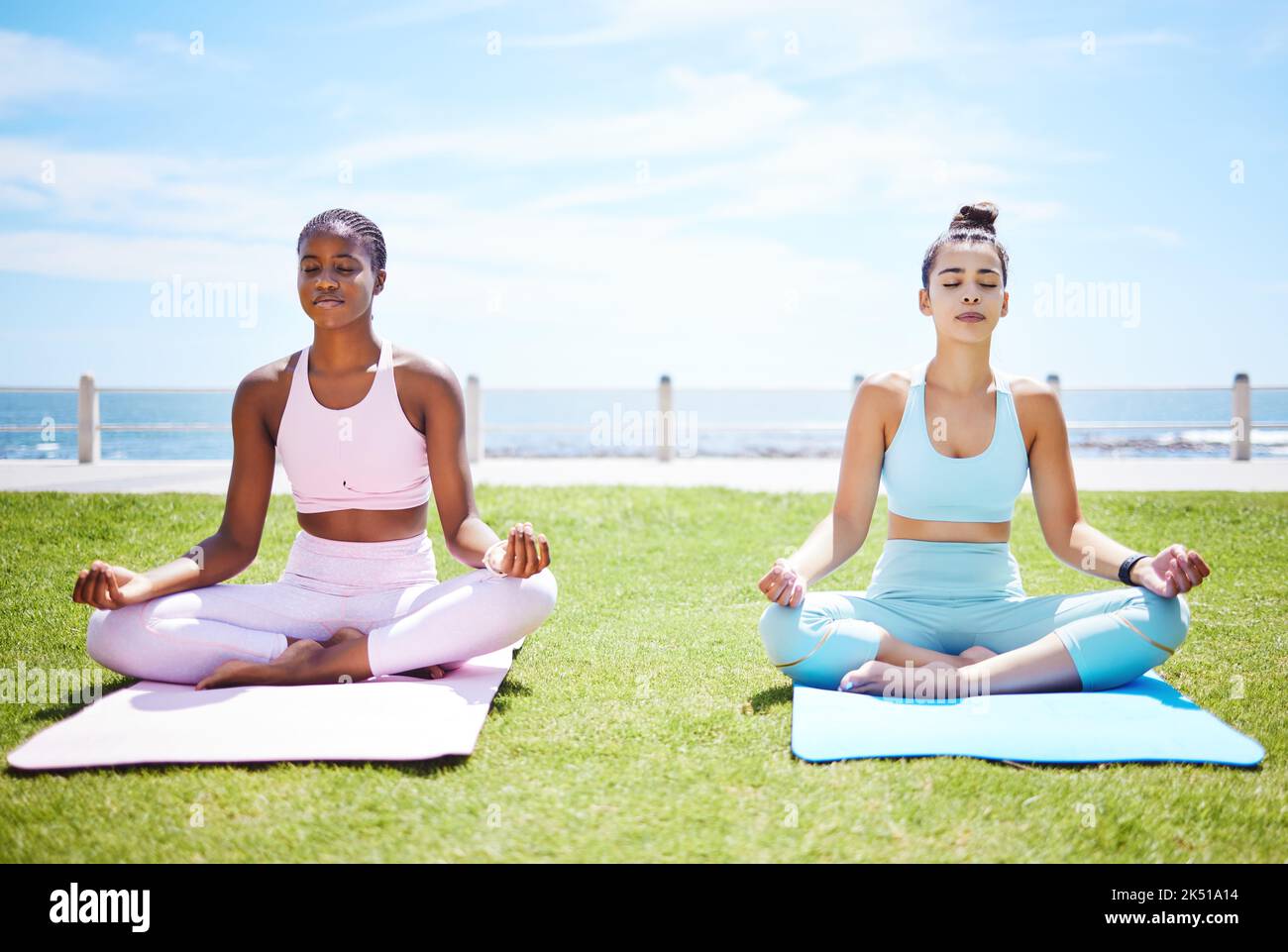 Women yoga meditation, peace and mudra hands in lotus pose for nature exercise, workout and zen energy outdoor grass. Calm, fitness and focus friends Stock Photo