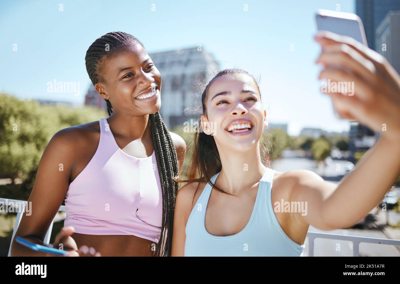 Fitness, woman and friends for phone selfie in exercise, training or workout together outside in the city. Active female in friendship smile for fun Stock Photo