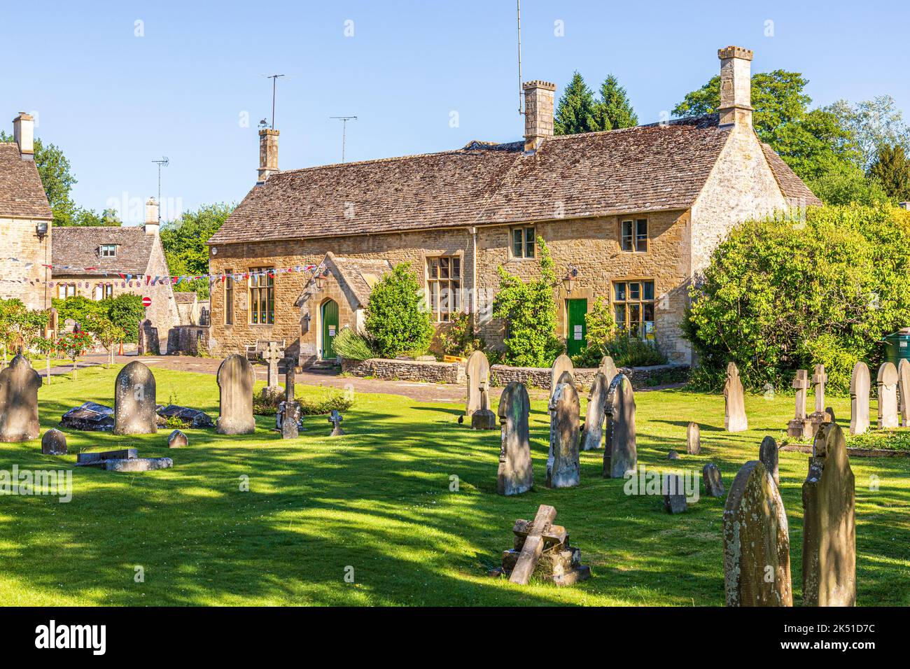 Early morning light in midsummer on the 19th century Church of England Primary School in the Cotswold village of Bibury, Gloucestershire, England UK Stock Photo