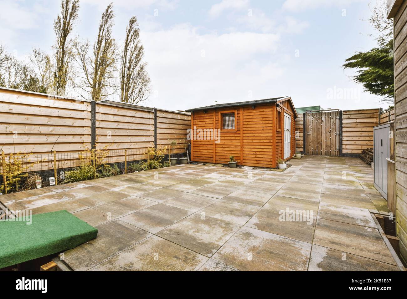Wooden shed located on terrace of exterior house in suburb area Stock