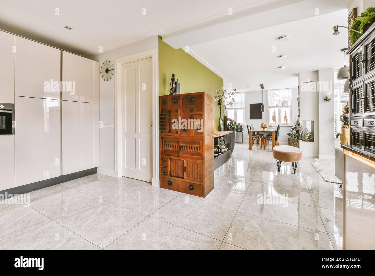 House interior entrance next to modern living room with dining areas