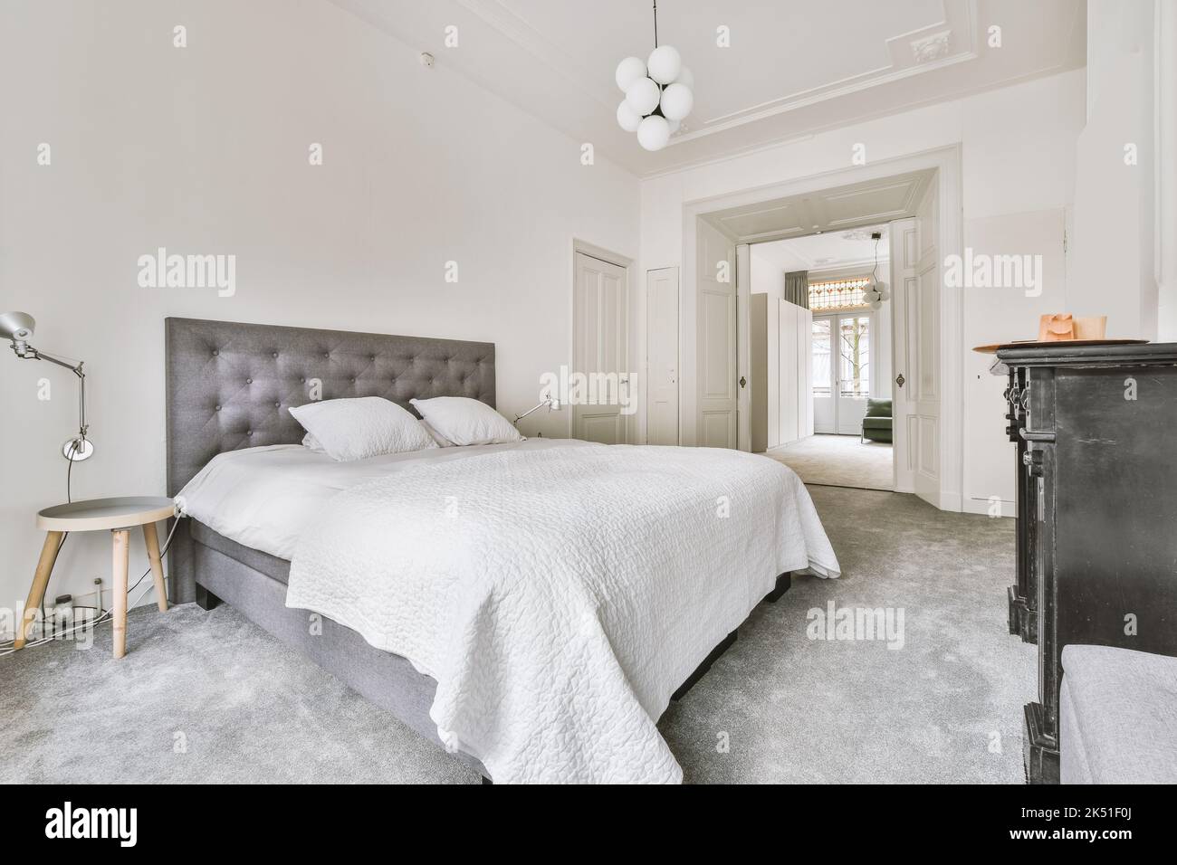 Comfortable bed located in bedroom in daytime at home Stock Photo Alamy