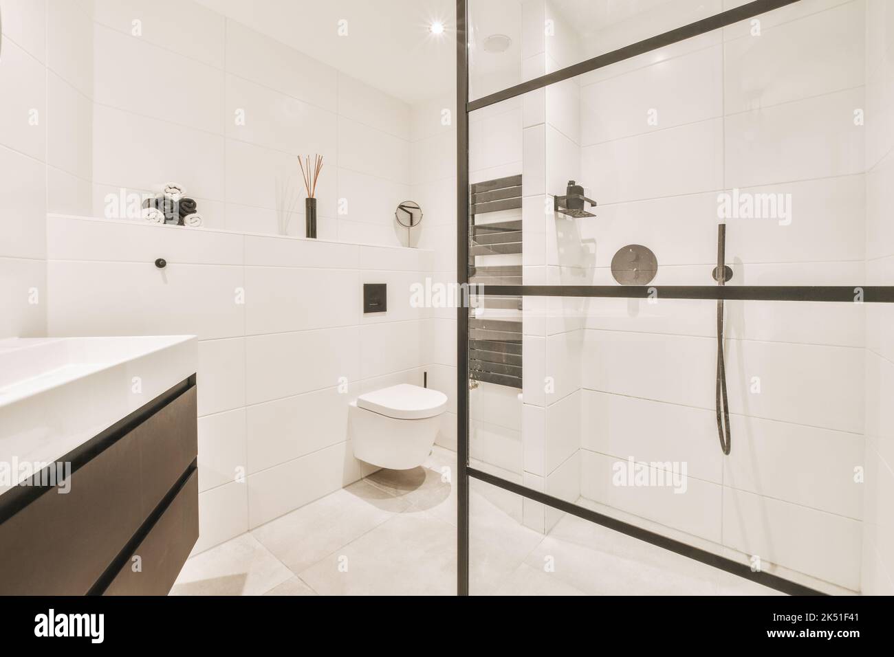 Interior of modern bathroom with white toilet bowl near glass wall of ...