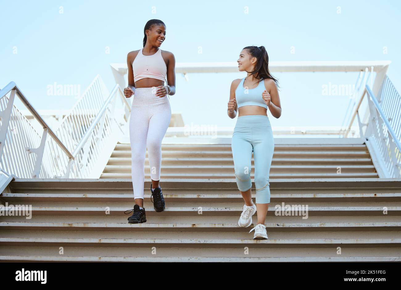 Fitness women, running steps and exercise for healthy lifestyle, wellness and marathon training in urban city outdoors. Happy athletes, runners and Stock Photo