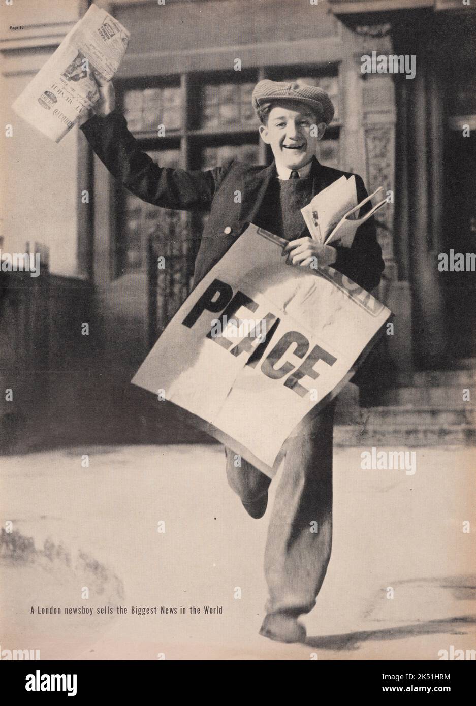 'A London news boy selling newspaper Headlined 'PEACE' after Daladier, Chamberlain and Hitler signed the Munich Agreement on September 30, 1938. Published on Life magazine, October 17,1938. Stock Photo