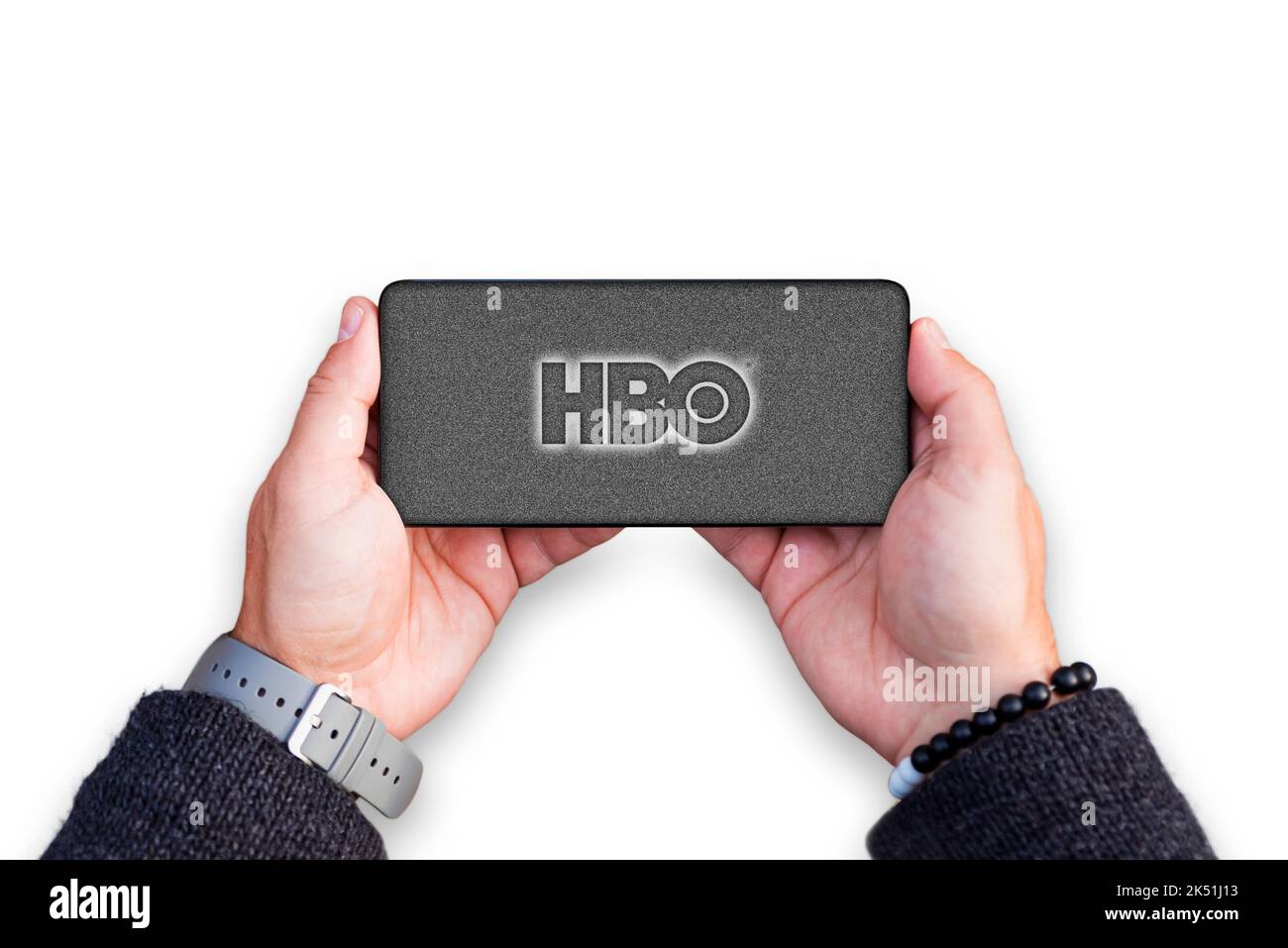 Belgrade, Serbia - October 05, 2022: Holding smartphone in hands with HBO logo on screen. Home Box Office is an American pay television network Stock Photo