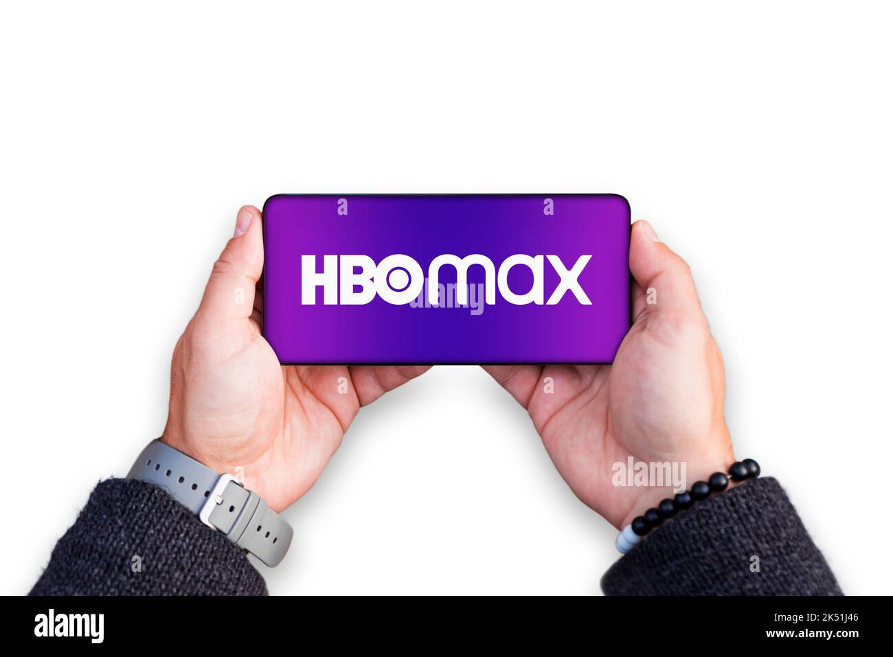 Belgrade, Serbia - October 05, 2022: Holding smartphone in hands with HBO logo on screen. HBO Max is an American subscription video on demand service Stock Photo
