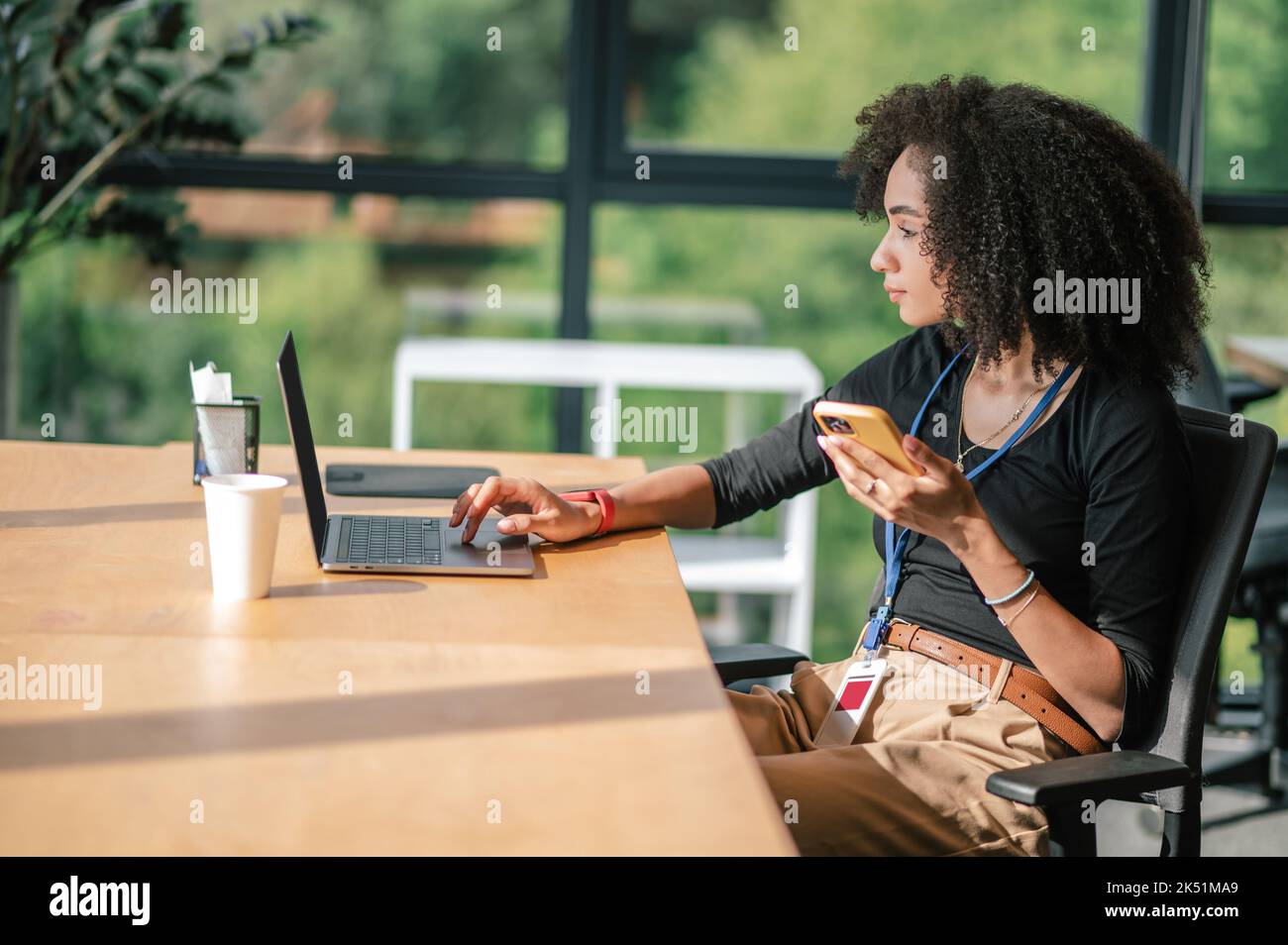 Pretty young businesswoman working in the office Stock Photo - Alamy