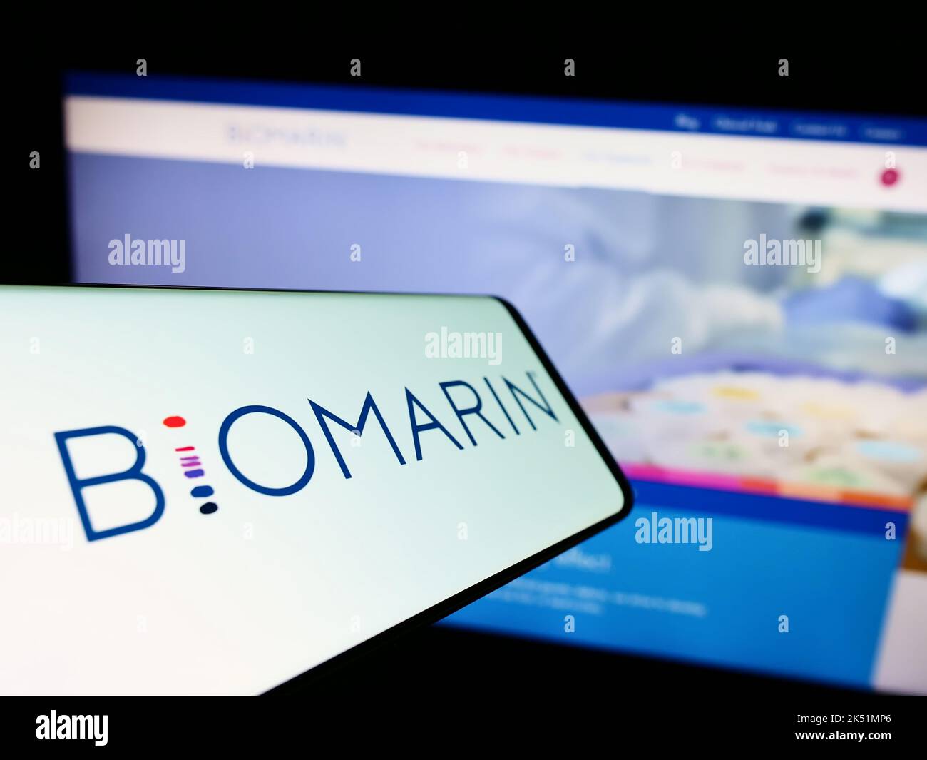 Mobile phone with logo of American company BioMarin Pharmaceutical Inc. on screen in front of website. Focus on center of phone display. Stock Photo
