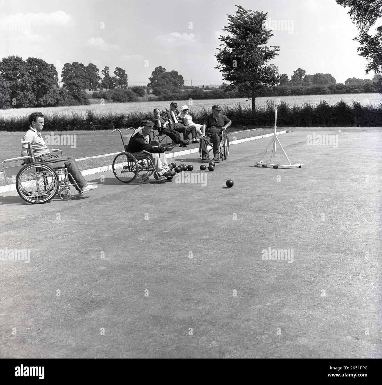 1964, historical, in the grounds of Stoke Mandeville Hospital, home of the National Spinal Injuries Centre - established in 1944 by Dr. Ludwig Guttmann - wheelchair competitors taking part in a bowls tournament. Stoke Mandeville in Aylesbury, Buckinghamshire, England, UK, was the birthplace of the Paralympic movement in 1948, the year of the post-war London Olympics, when the first competition for wheelchair athletes took place. 16 injured serviceman and women took part in what was known as the Stoke Mandeville Games, which later became the Paralympic Games. Stock Photo