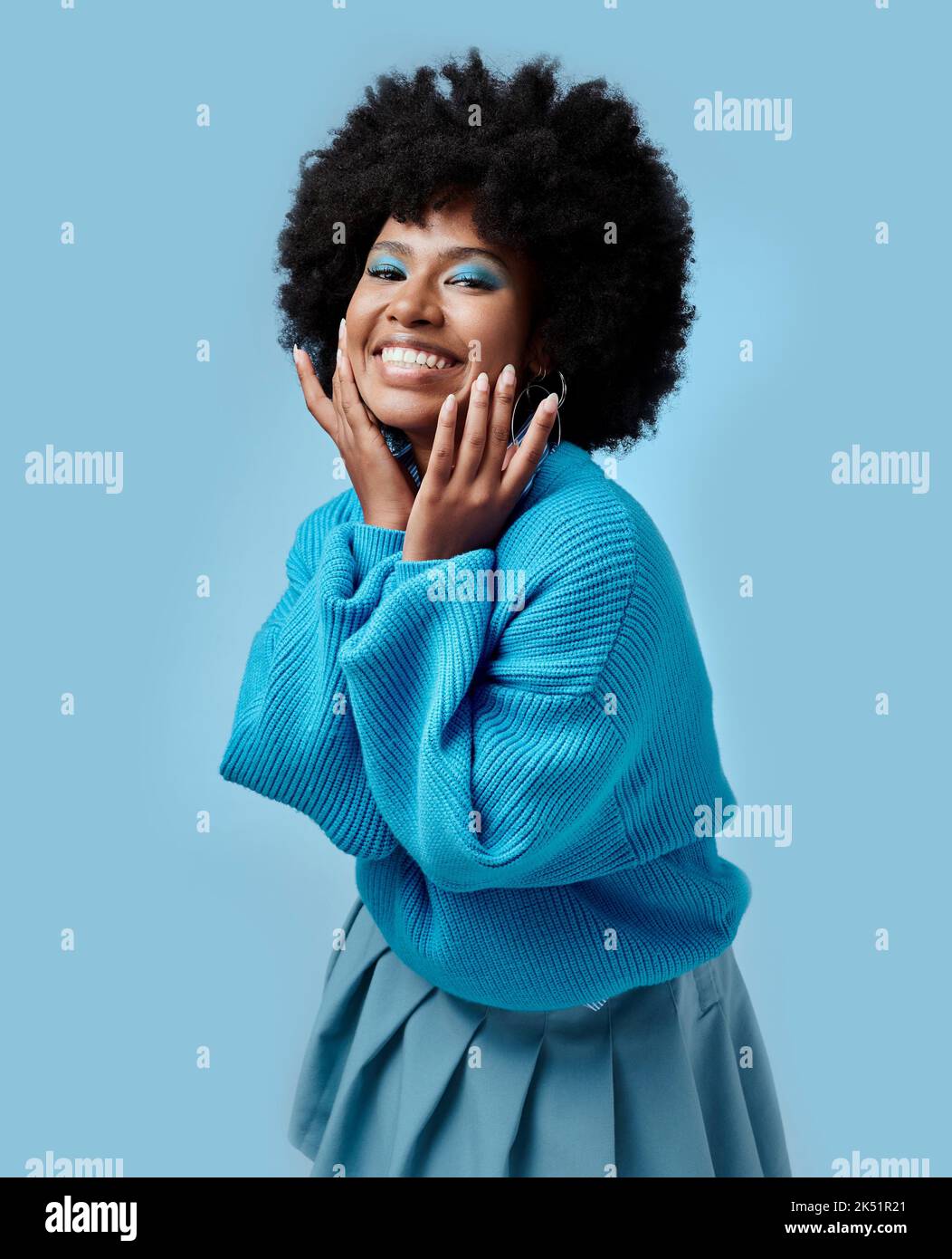 African beauty, makeup and portrait of a black woman with blue eyes shadow, face cosmetics and afro hair or good skin. Funk, smile and young happy Stock Photo
