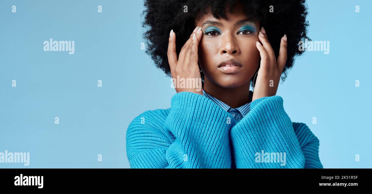 Blue makeup, fashion and beauty with a black woman in studio against a
