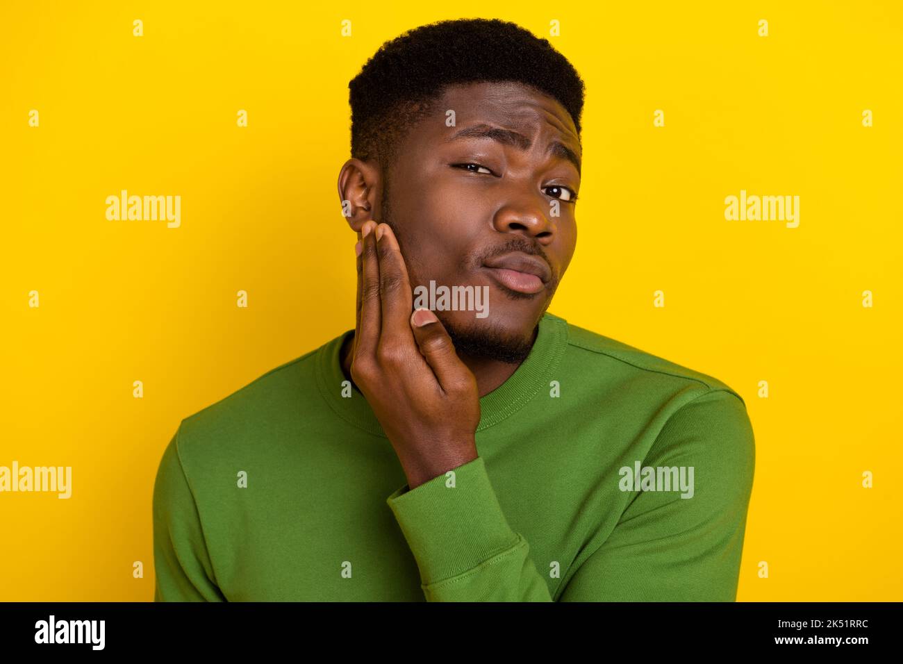 Portrait of attractive well-groomed guy touching cheek facial ...