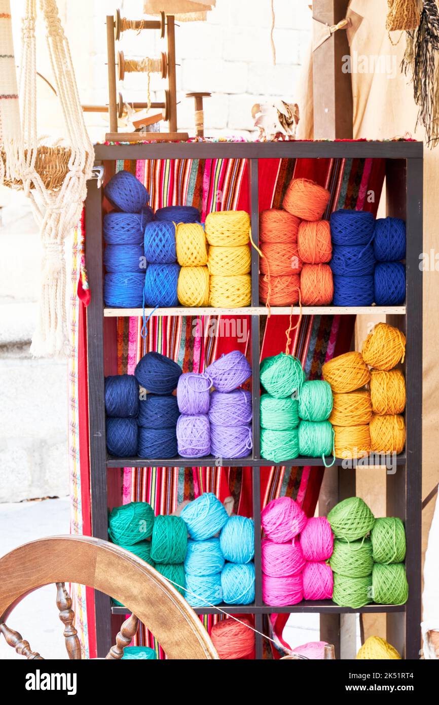Different colored balls of wool on a shelf. Craftsmanship Stock Photo