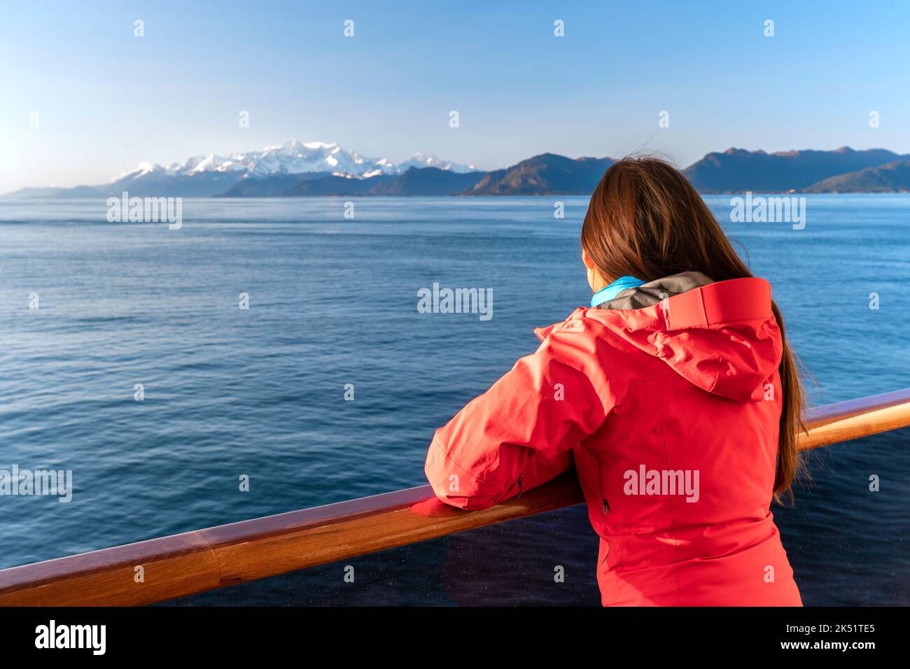 Alaska cruise travel tourist looking at mountains landscape from balcony deck of ship. Inside passage Glacier bay scenic vacation travel woman Stock Photo