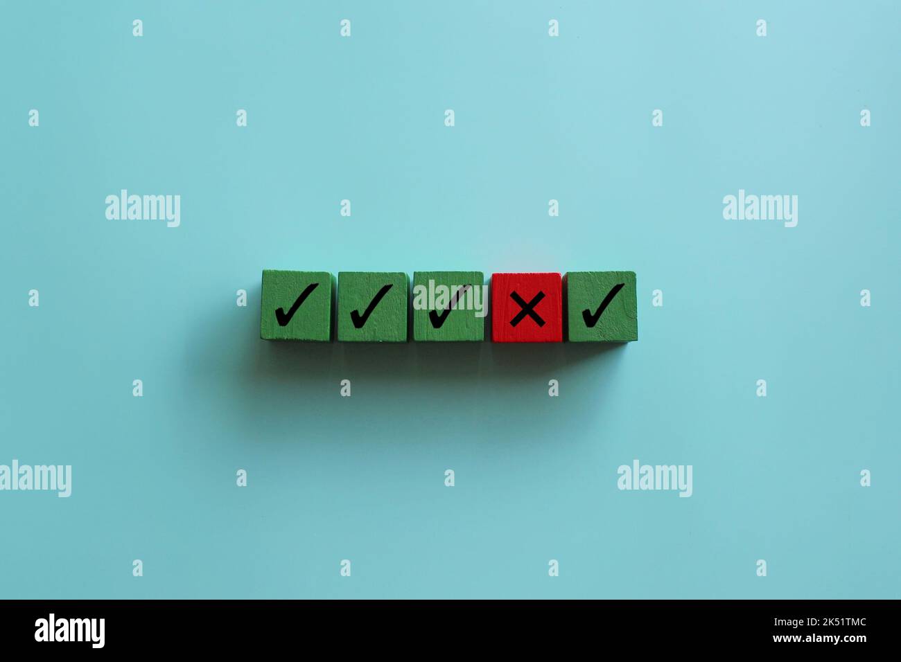 Wooden cubes with right and wrong icon. Violation contract terms, termination, corruption, failure to comply, system vulnerability concept Stock Photo