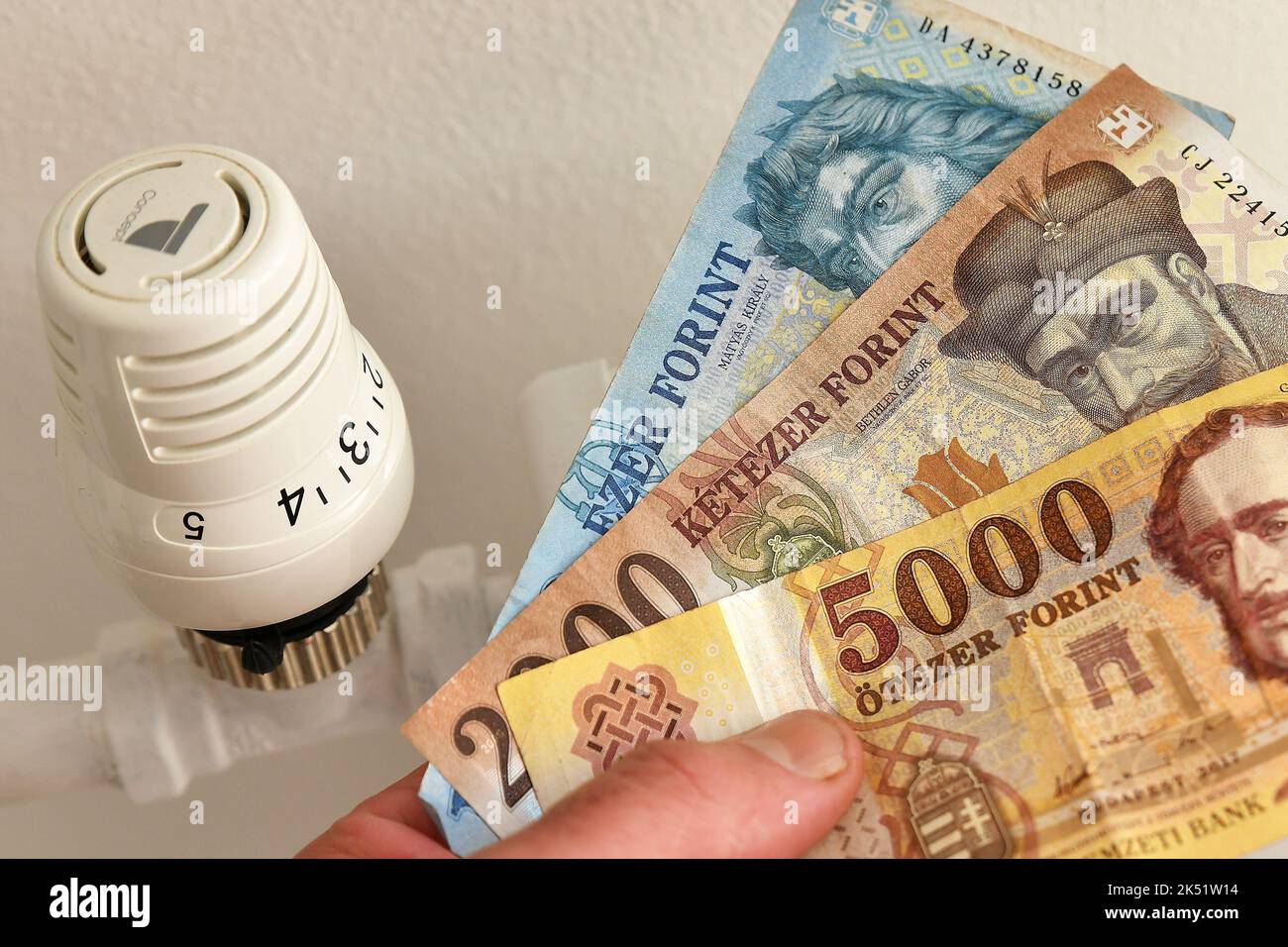 Illustration photo - a thermostat on a modern heating system in an apartment with Banknotes of the Hungarian forint. Money. Measurement and regulation Stock Photo