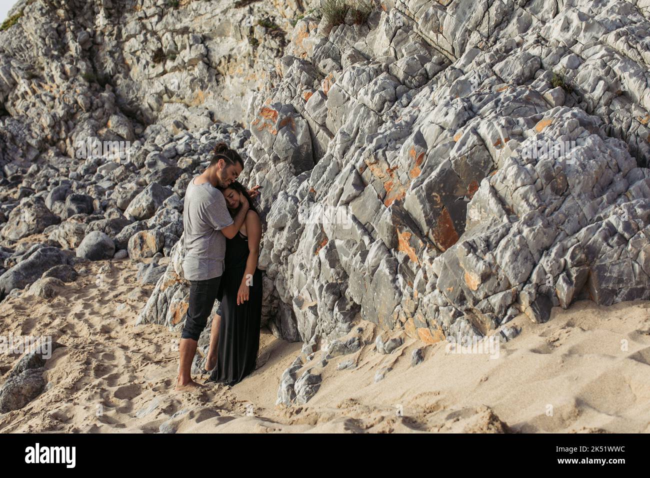 Man Hugging Rocks full length of smiling man hugging girlfriend in dress while standing ...