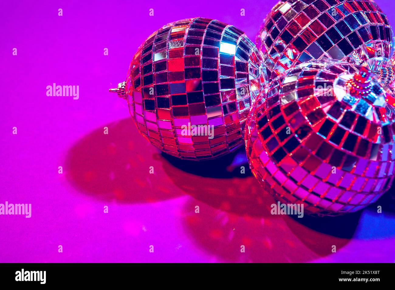 Shiny small disco balls sparkling in a beautiful purple light. Disco party  concept Stock Photo - Alamy