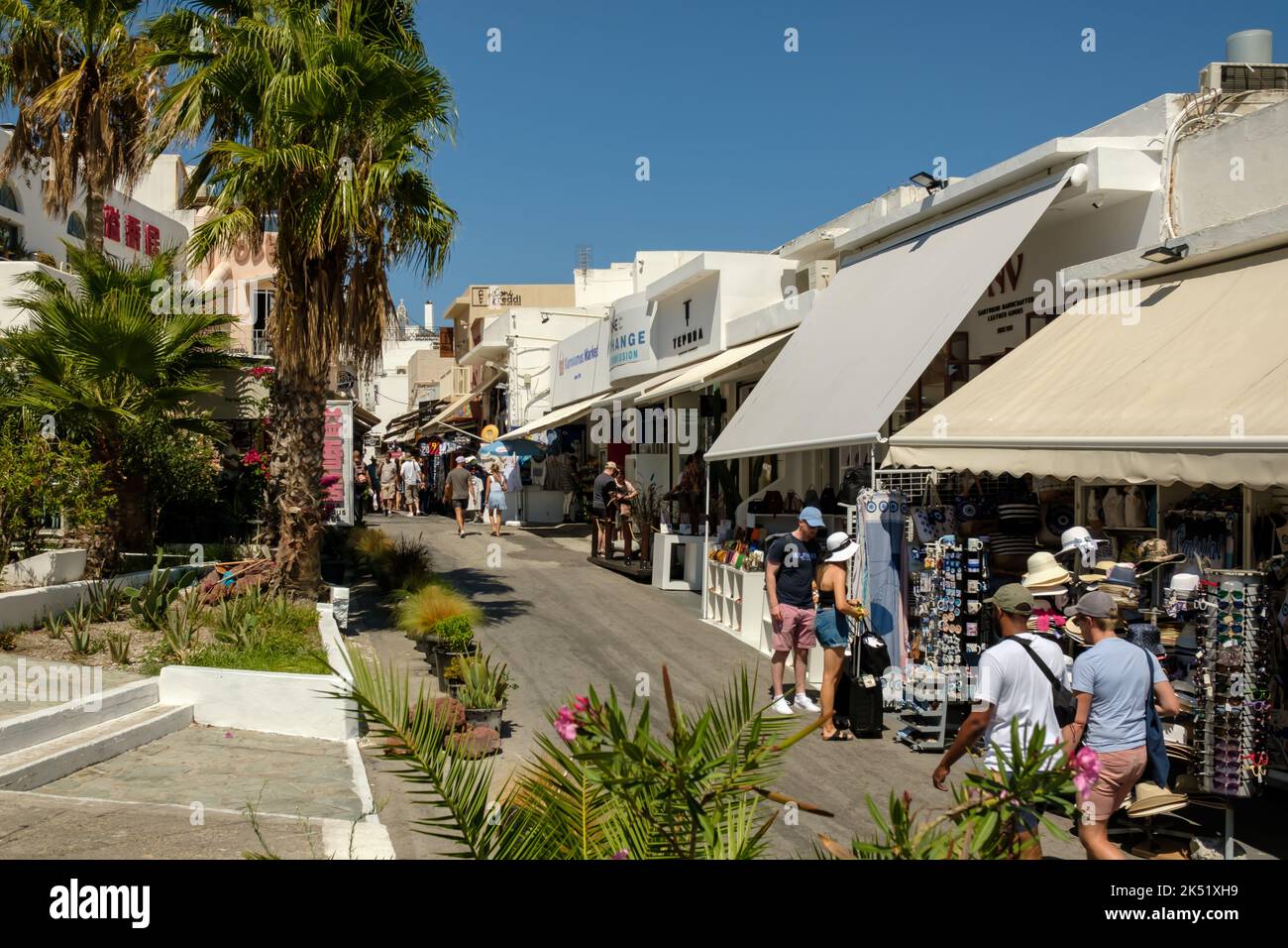 Fira, Greece - September 5, 2022 : View of tourists walking next to souvenir shops in the center of Fira Santorini Greece Stock Photo