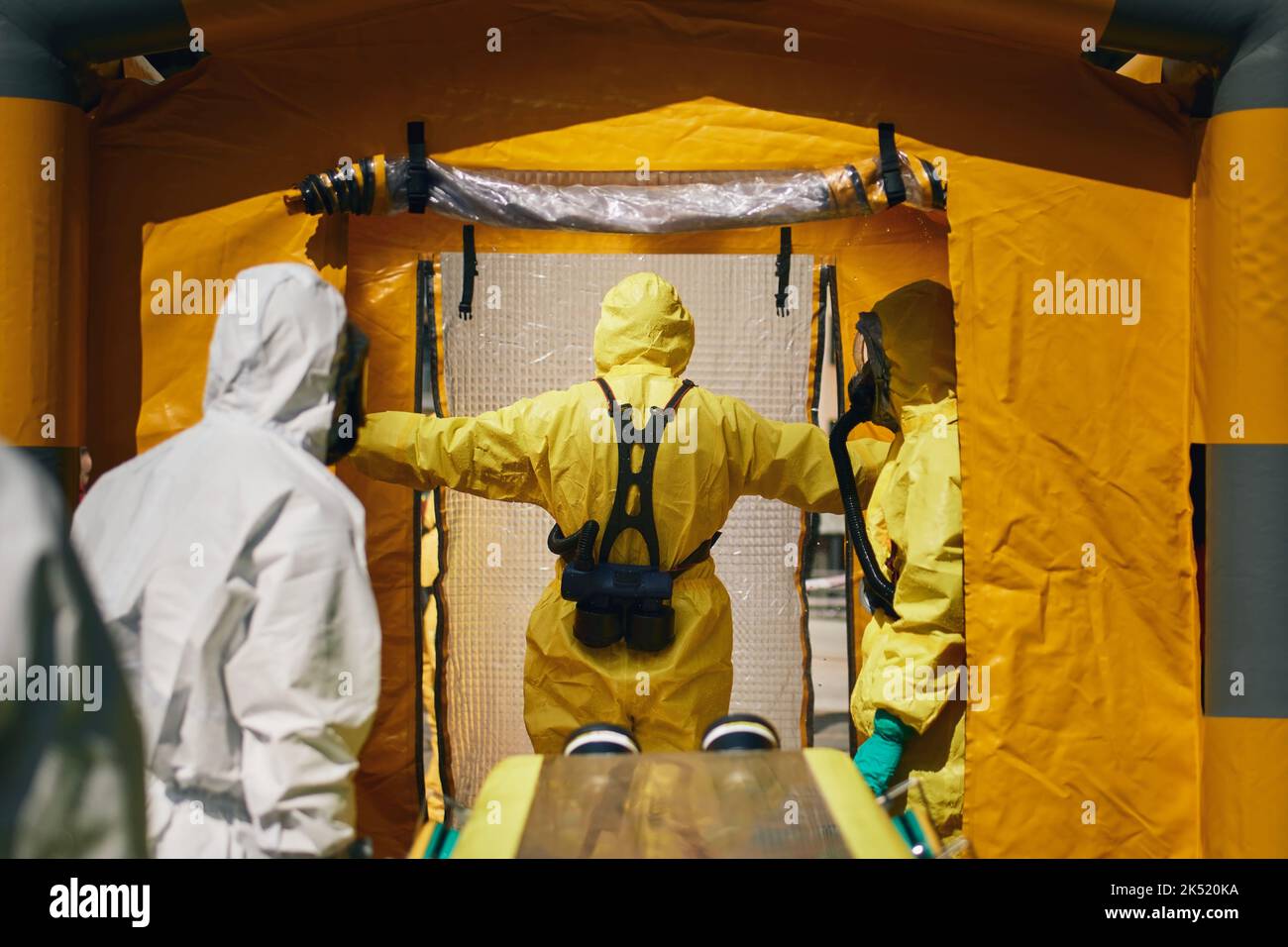 Members of biohazard teams of fire brigade and emergency medical service in protective suits