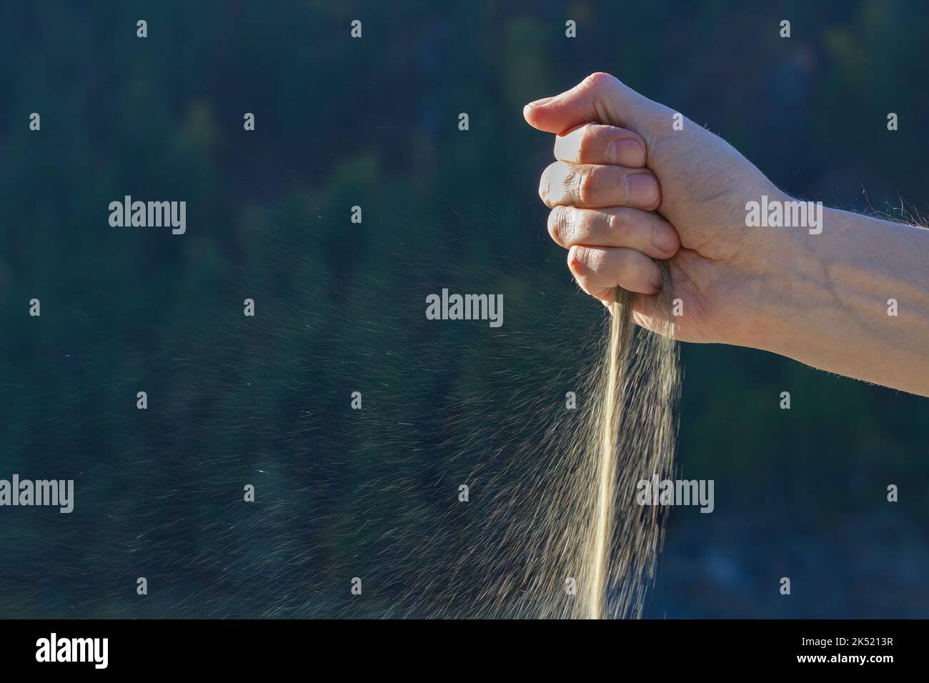 Time goes by and sand falls through hand, selective focus. Pensiveness, Anxiety and Time for Change. Sand pouring through men's fingers, transience of Stock Photo