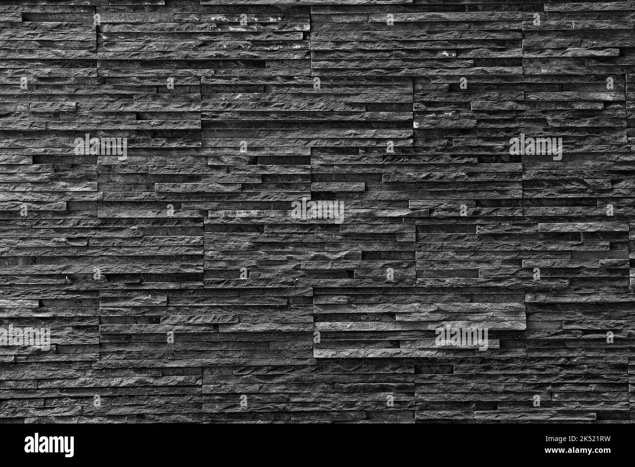 Black stone wall Texture in weathered and have natural surfaces for