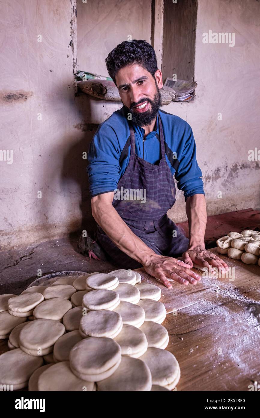 A man preparing dough for bread in Leh, Ladakh, India Stock Photo
