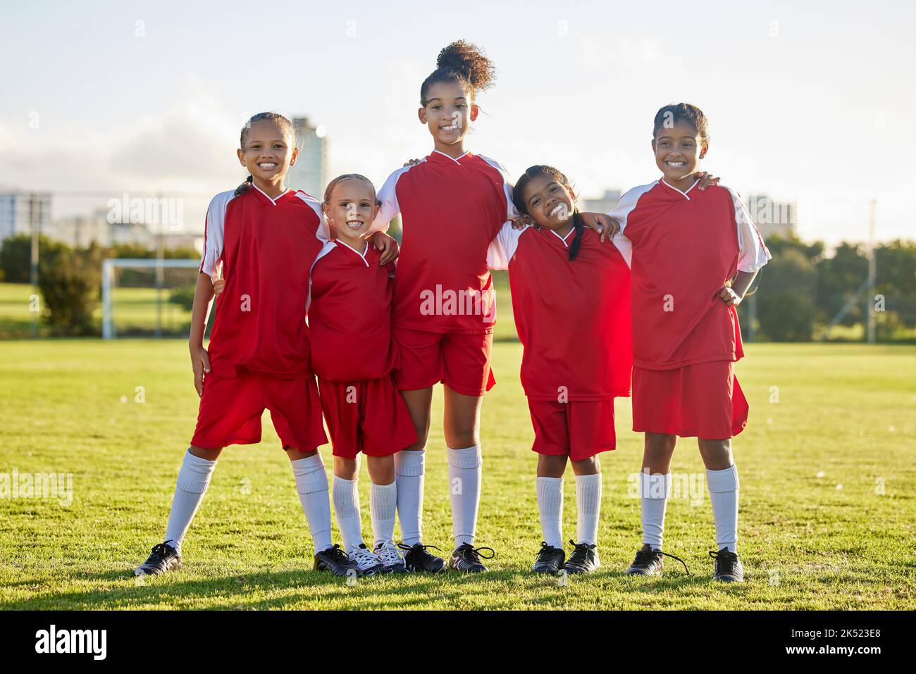Girl team, kids on soccer field and sports development for happy girls in group portrait
