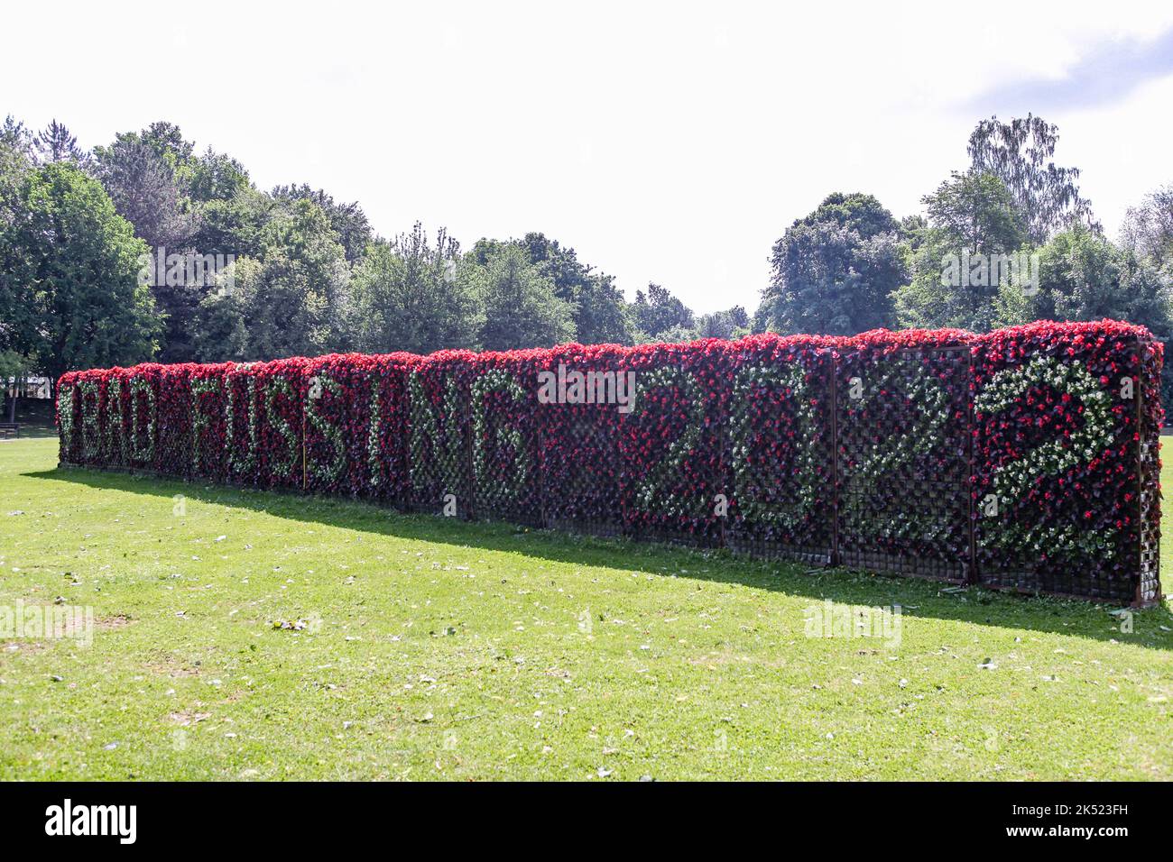 Frame with inscription 'Bad Füssing from flowers with red background from cyclamen Stock Photo