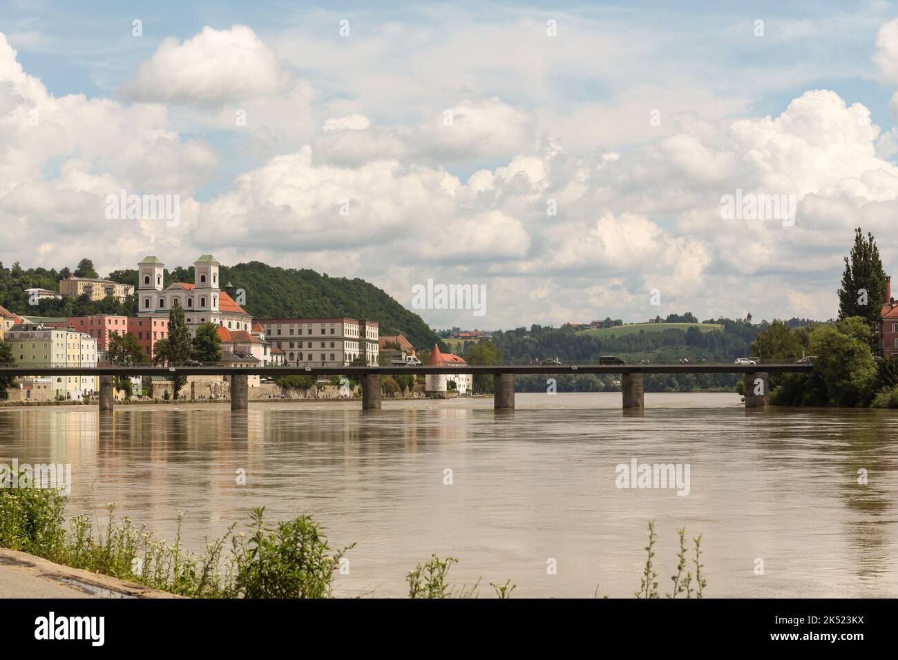 Old bridge over the river Inn, with the city of Passau in the background Stock Photo