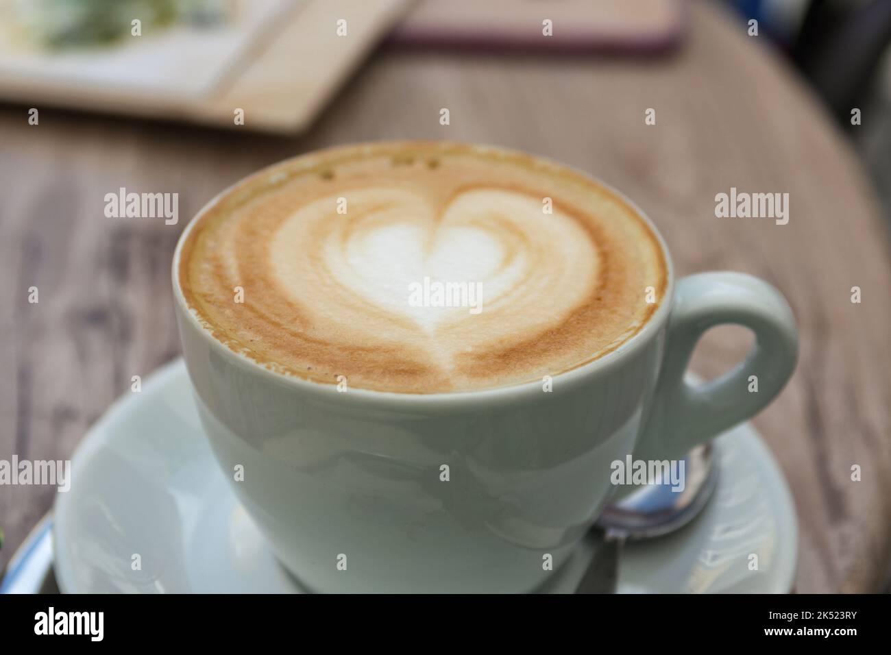 A cup of cappuccino with a heart of milk foam Stock Photo
