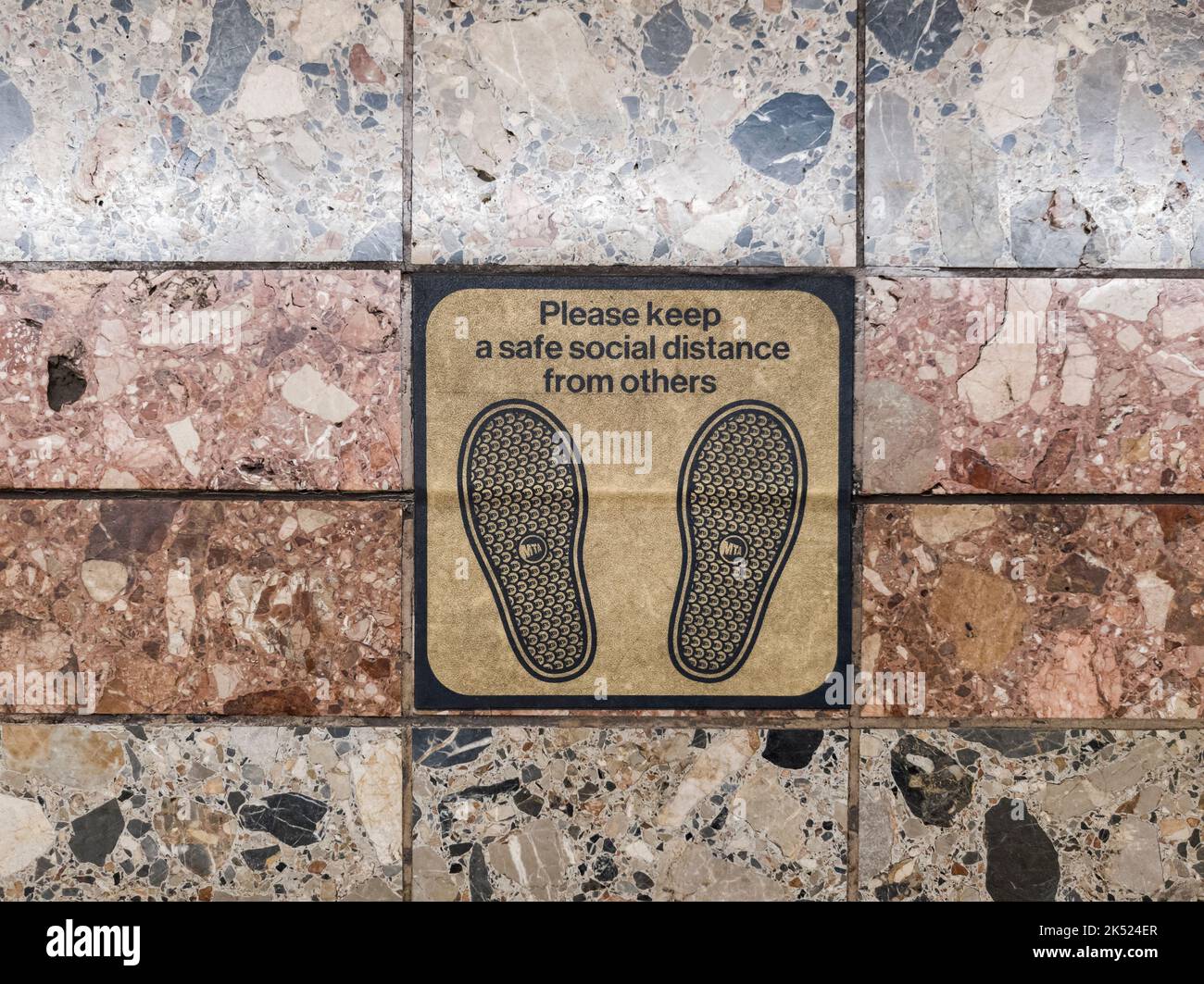 A worn social distancing sticker on the floor of a platform in the subway in New York on Saturday, October 1, 2022. The stickers were originally applied in 2020 during the pandemic. (© Richard B. Levine) Stock Photo