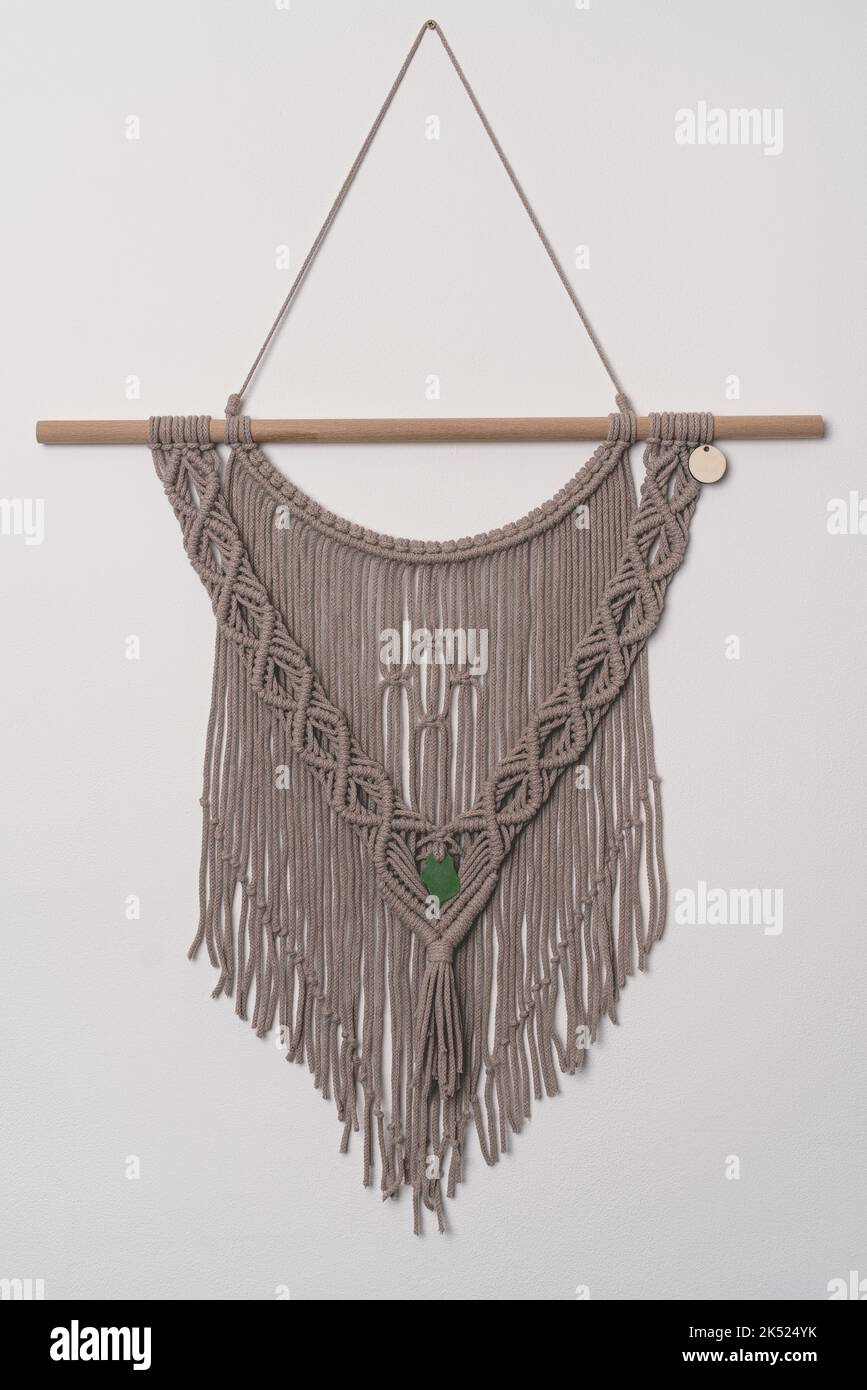 Hand made macrame wall hanging fiber art decoration with heart symbol