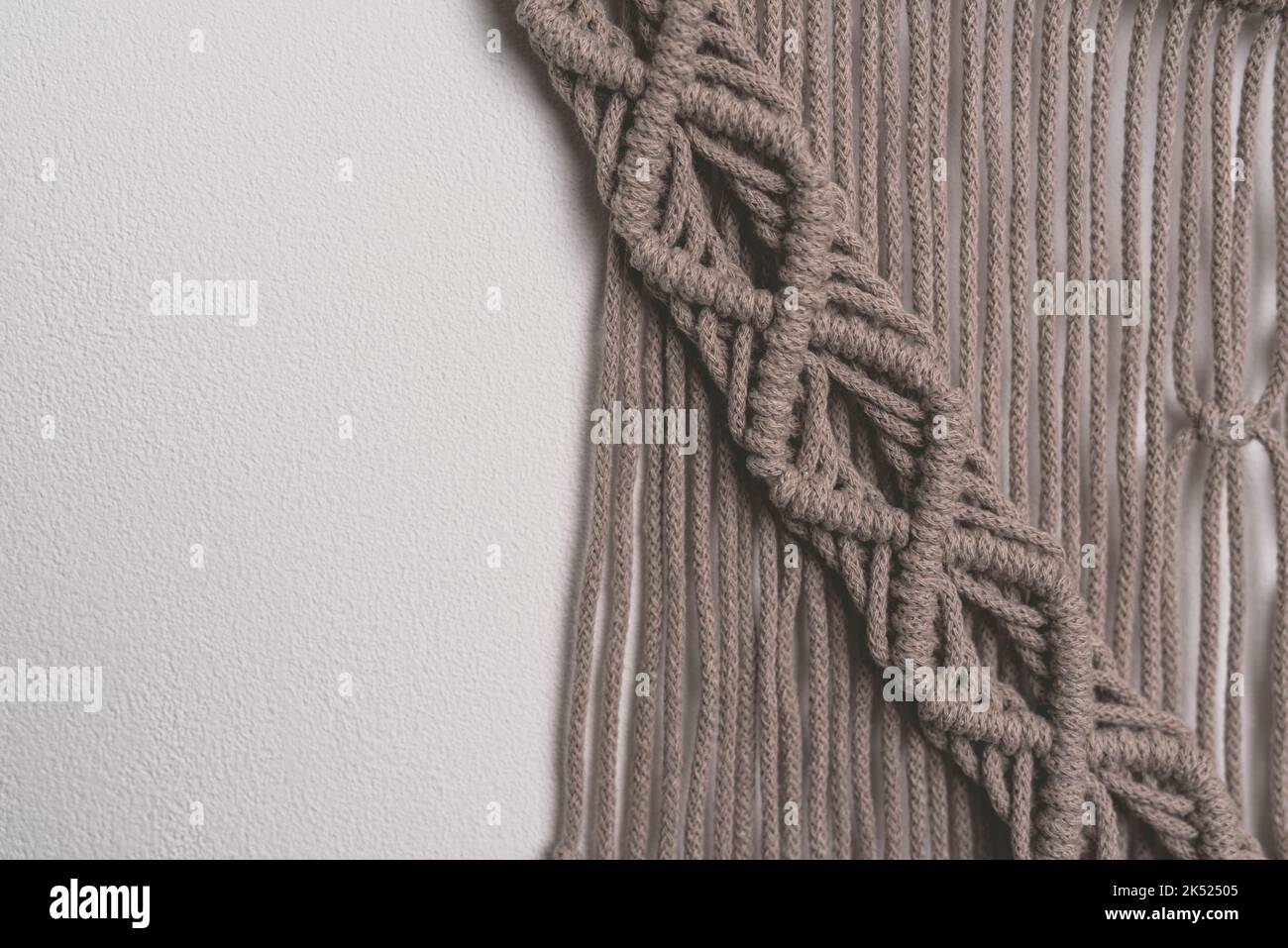 Hand made macrame wall hanging fiber art decoration with heart symbol