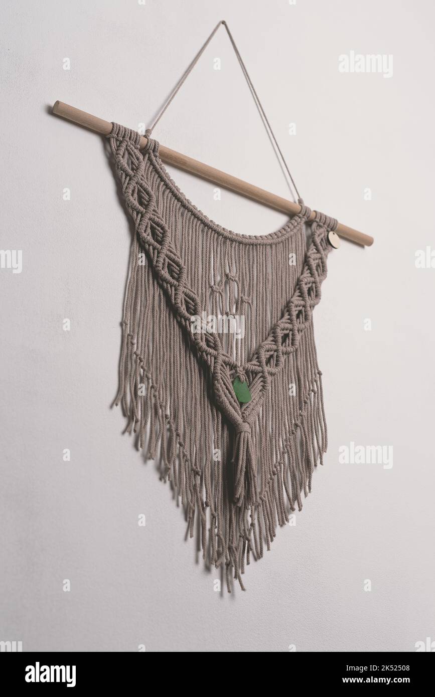 Hand made macrame wall hanging fiber art decoration with heart symbol