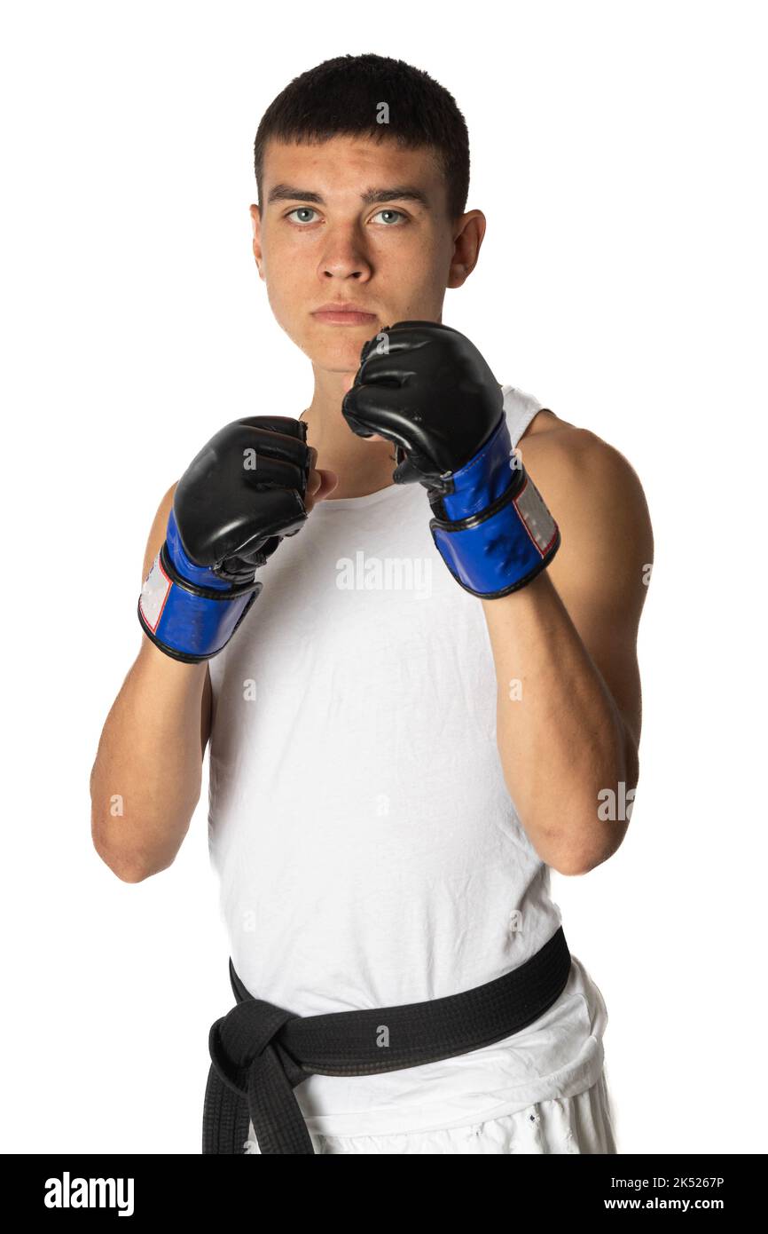 A 19 year old teenage karate black belt posing wearing fighting gloves