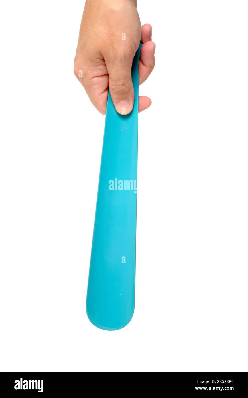 Shoe spoon in hand, on a white background Stock Photo