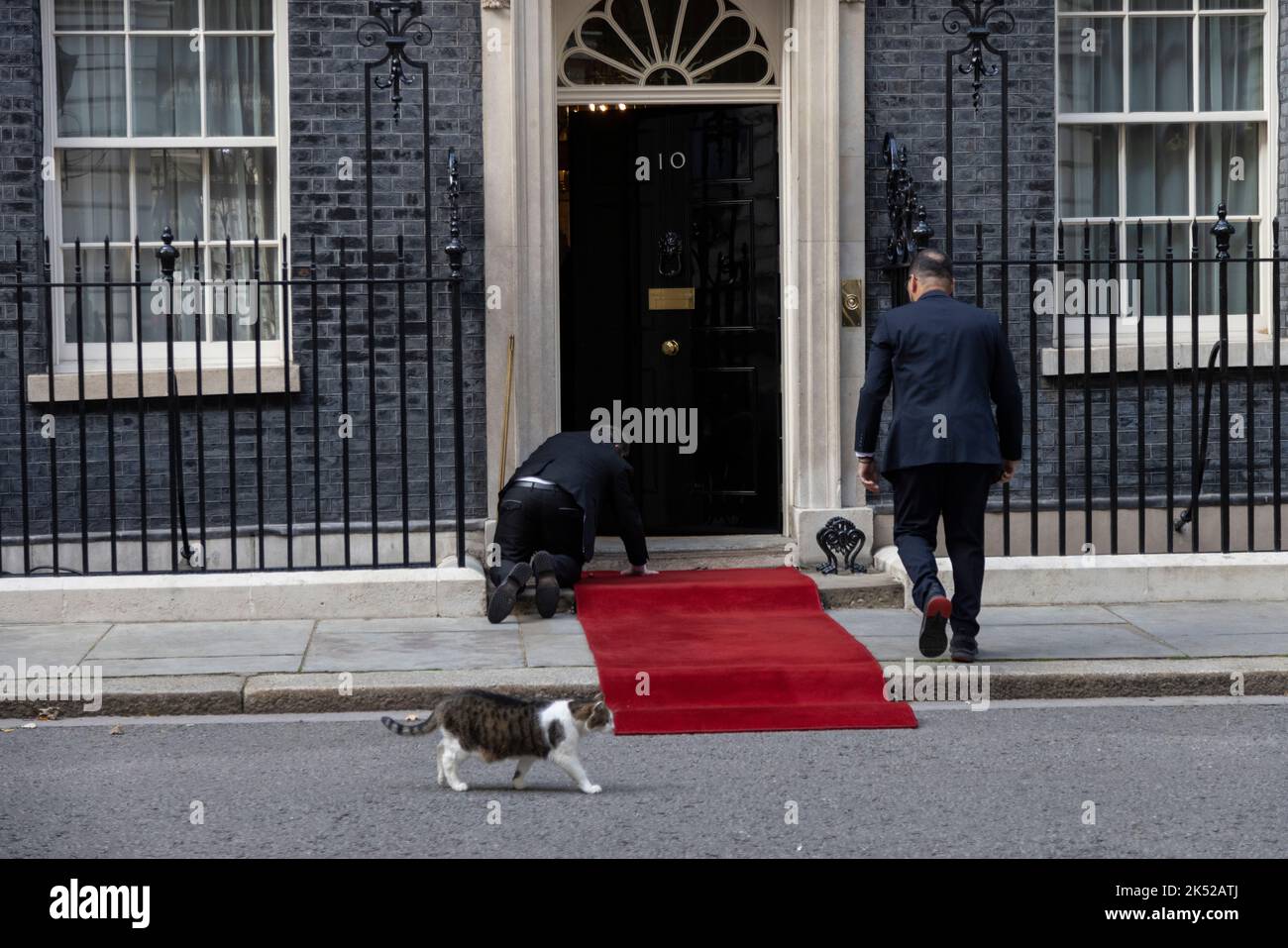 Red carpet is laid in front of the main No.10 Downing Street entrance doorway ahead of a State visit, Whitehall, London, England, UK Stock Photo