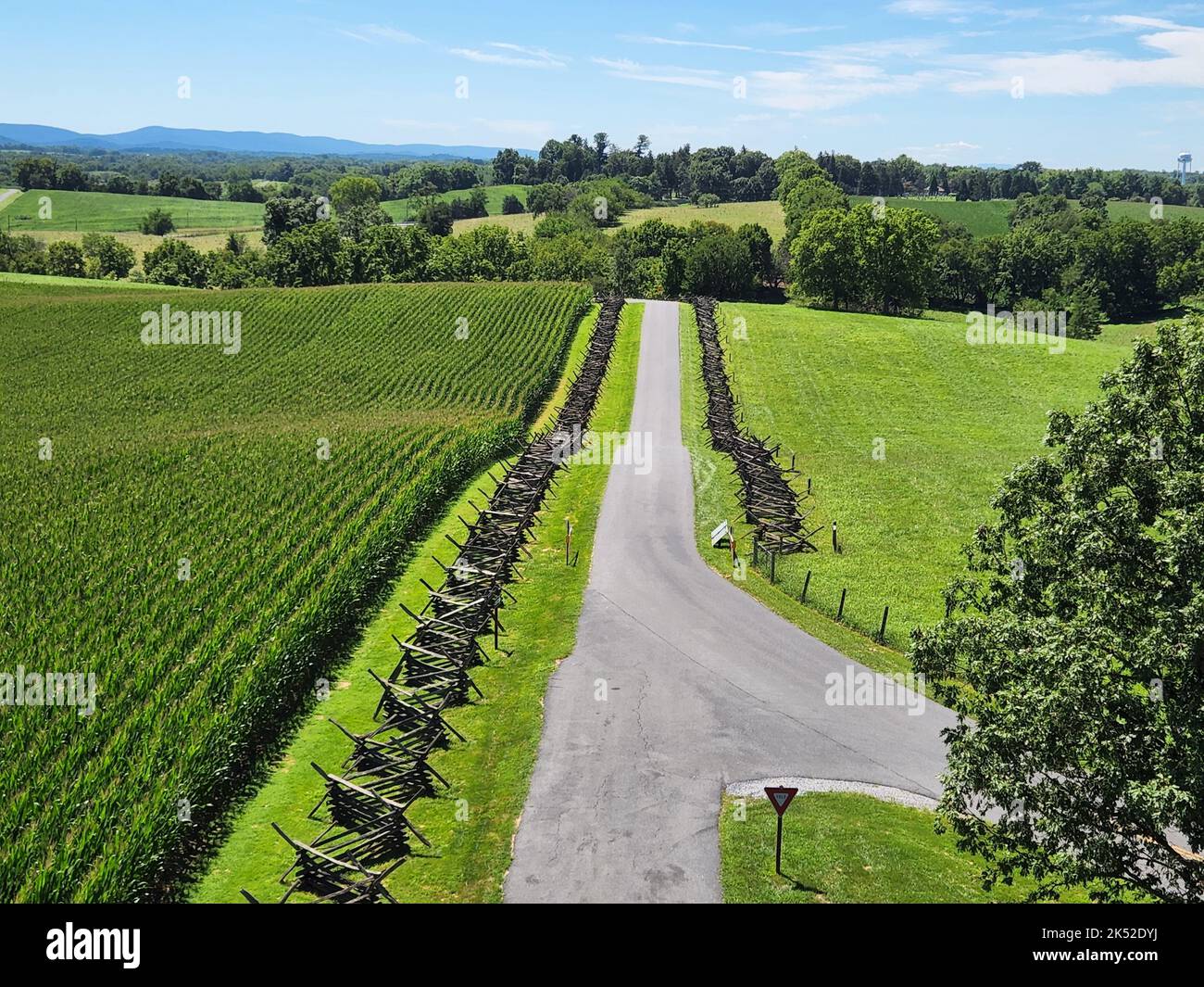 The beautiful green yards of a winery with a pathway against the blue sky Stock Photo