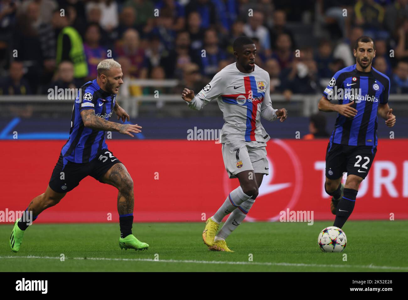 Milan, Italy, 4th October 2022. Ousmane Dembele of FC Barcelona takes n Federico Dimarco and Henrikh Mkhitaryan of FC Internazionale  during the UEFA Champions League Group C match at Giuseppe Meazza, Milan. Picture credit should read: Jonathan Moscrop / Sportimage Stock Photo