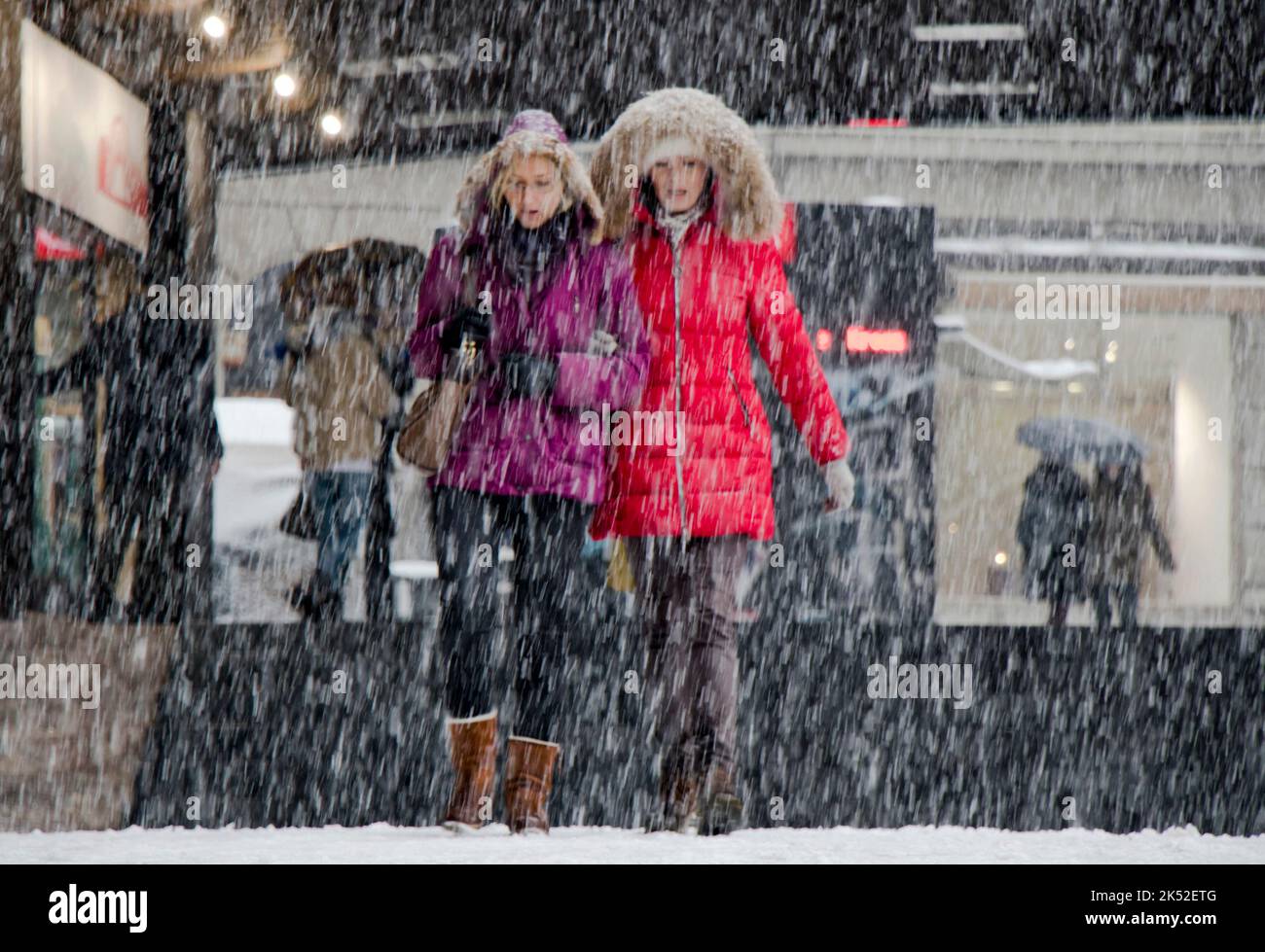 Belgrade, Serbia - December 15, 2018: Two young women walking city street on a snowy day Stock Photo