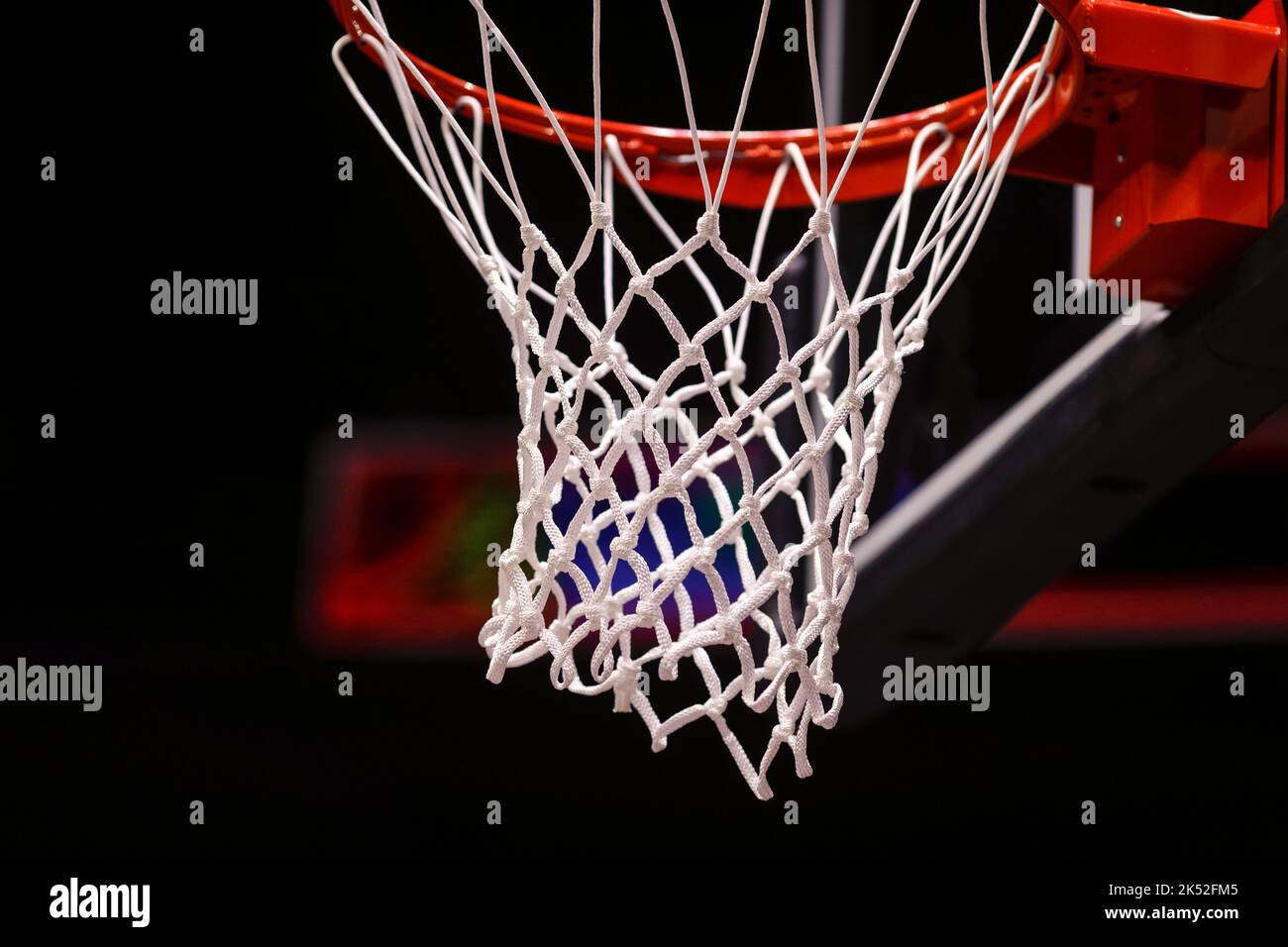 Shallow depth of field (selective focus) details with a basketball panel and net before an official game. Stock Photo