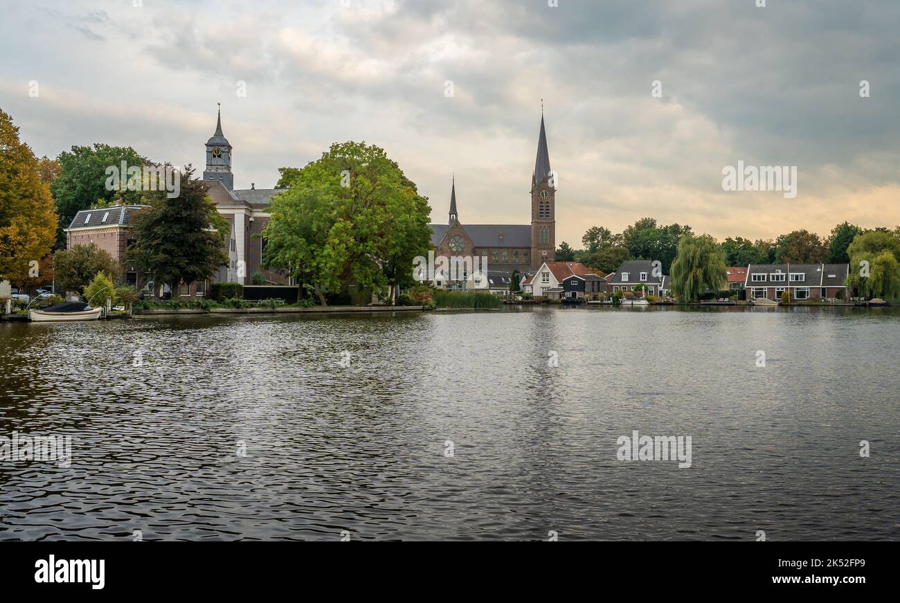 Dutch town Ouderkerk aan de Amstel, view of the church on the bank of river Amstel Stock Photo