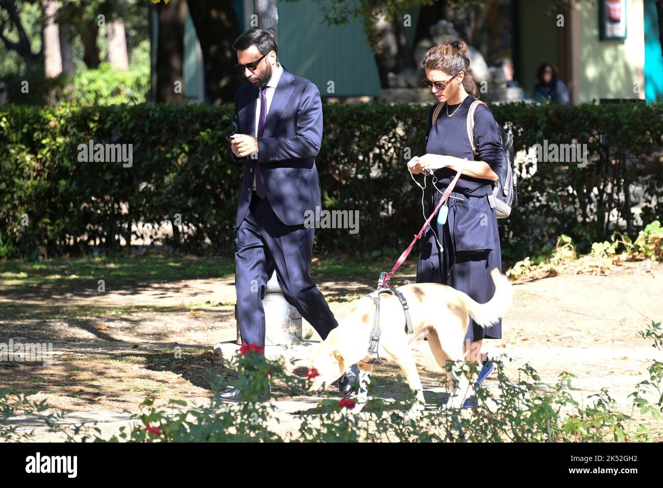 Catrinel Marlon (R) and companion Massimiliano Di Lodovico (L) walk