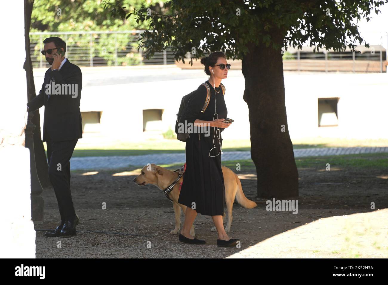 Catrinel Marlon (R) and companion Massimiliano Di Lodovico (L) walk